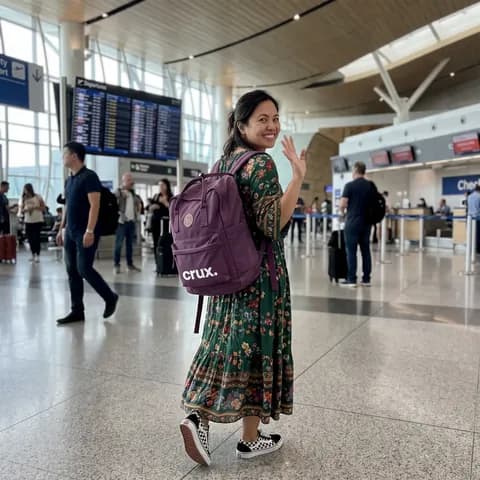 A traveler with a backpack in an airport terminal